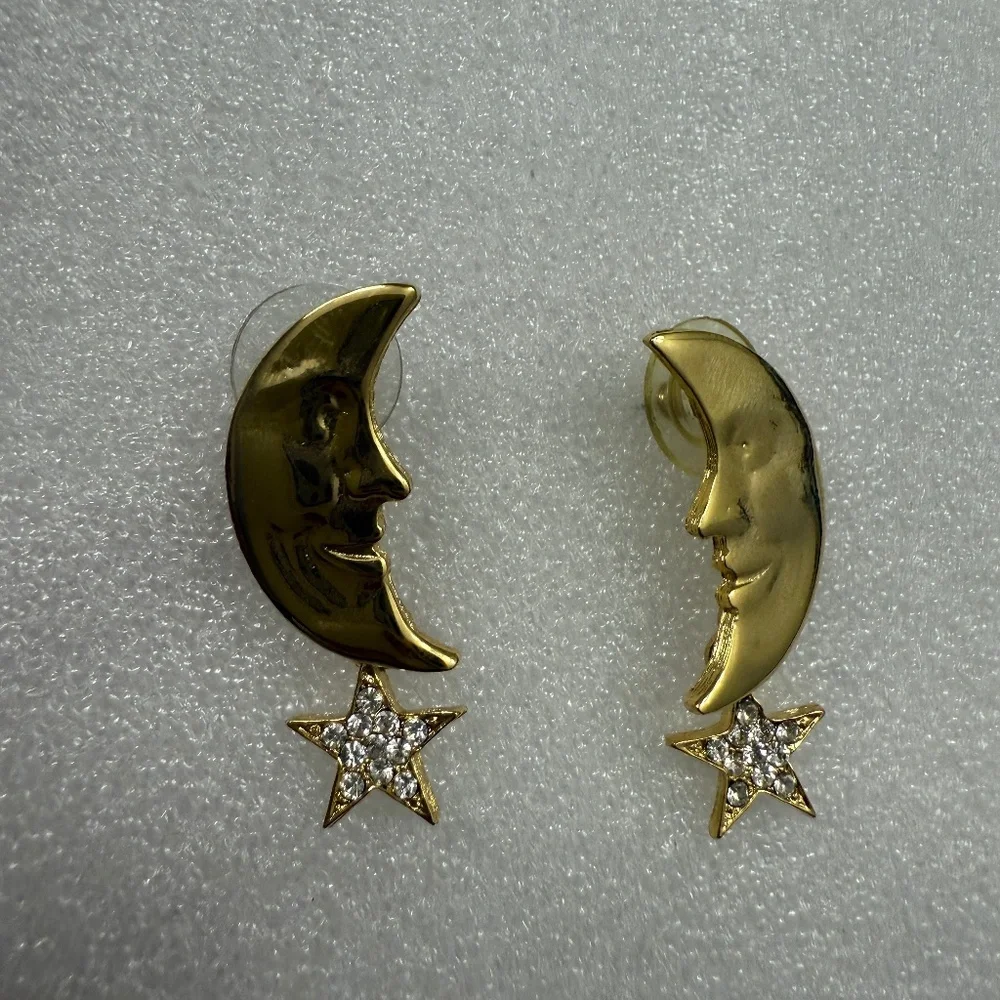 Pair of gold colored cresent earings with‎ star dangle
